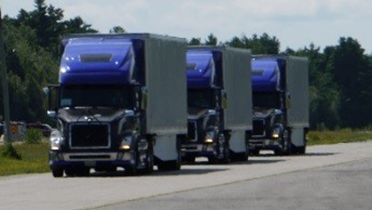 thsc-201804-8 Three semi trucks platooning on a highway