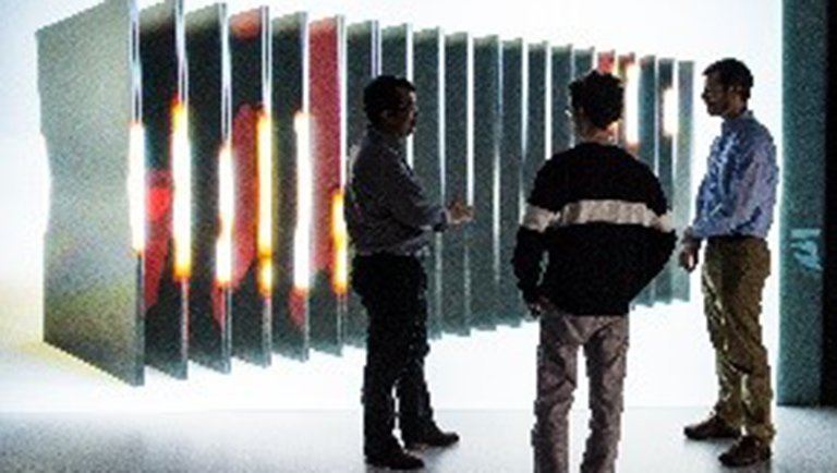 thsc-201804-9 NREL energy storage researchers evaluate simulation stills of a battery in the ESIF 3-D visualization room